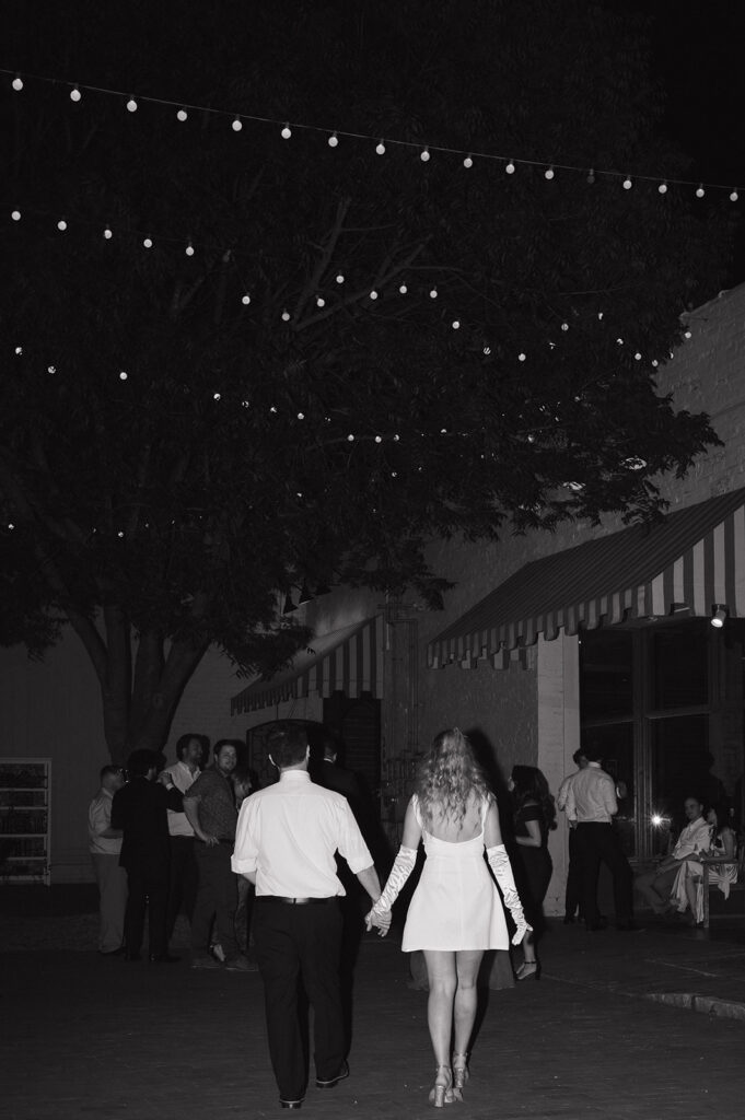 bride and groom walking towards their wedding reception
