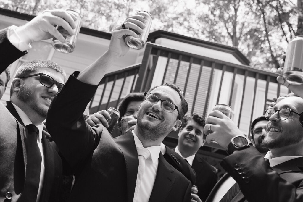 groom and groomsmen cheersing together before the ceremony