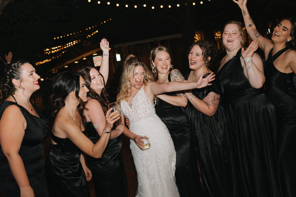 bride and bridesmaids laughing during their wedding reception