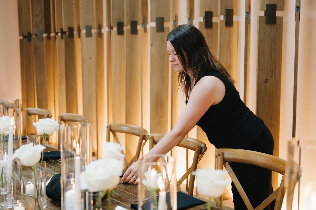 wedding planner putting the finishing touches on a wedding table