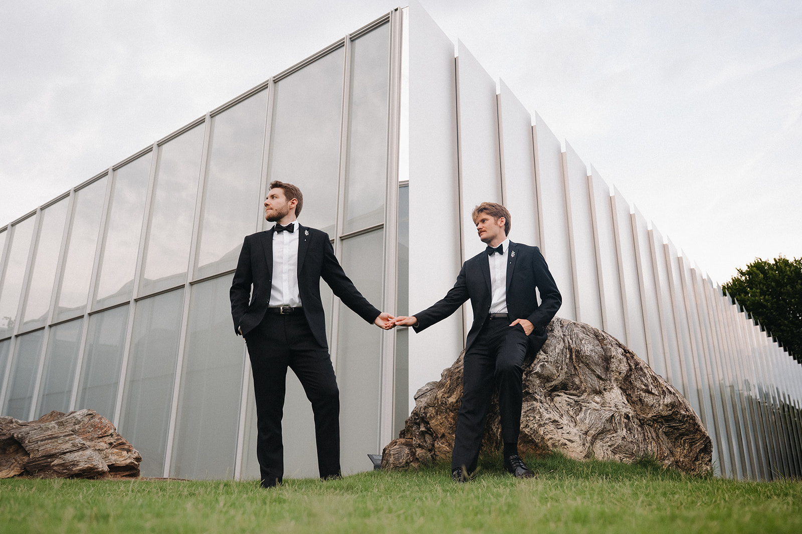 couple holds hands in front of NCMA wedding venue