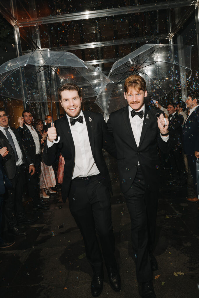 couple making their grand exit with bubbles and umbrellas